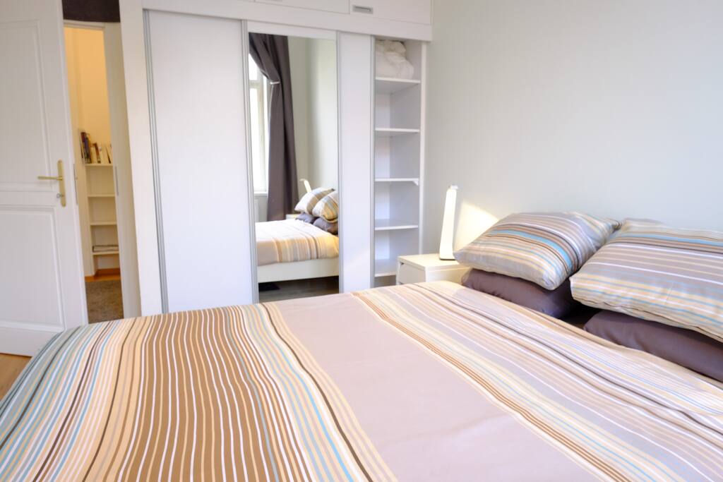 Bright and modern bedroom, queen size bed and ample storage space