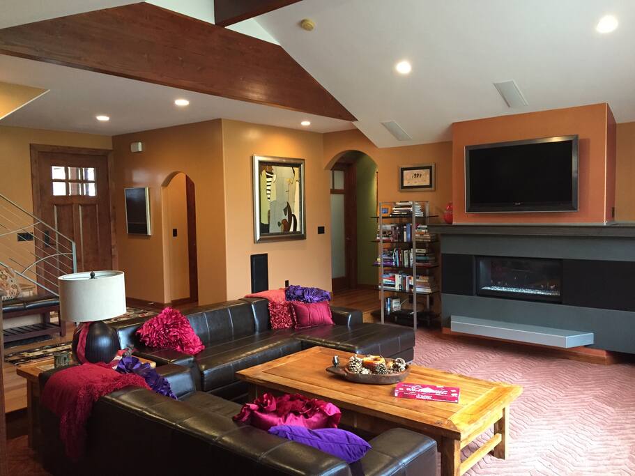 Living room with fireplace and surround sound. In ceiling speakers can play music in various rooms around the house. Bring your iPod.
