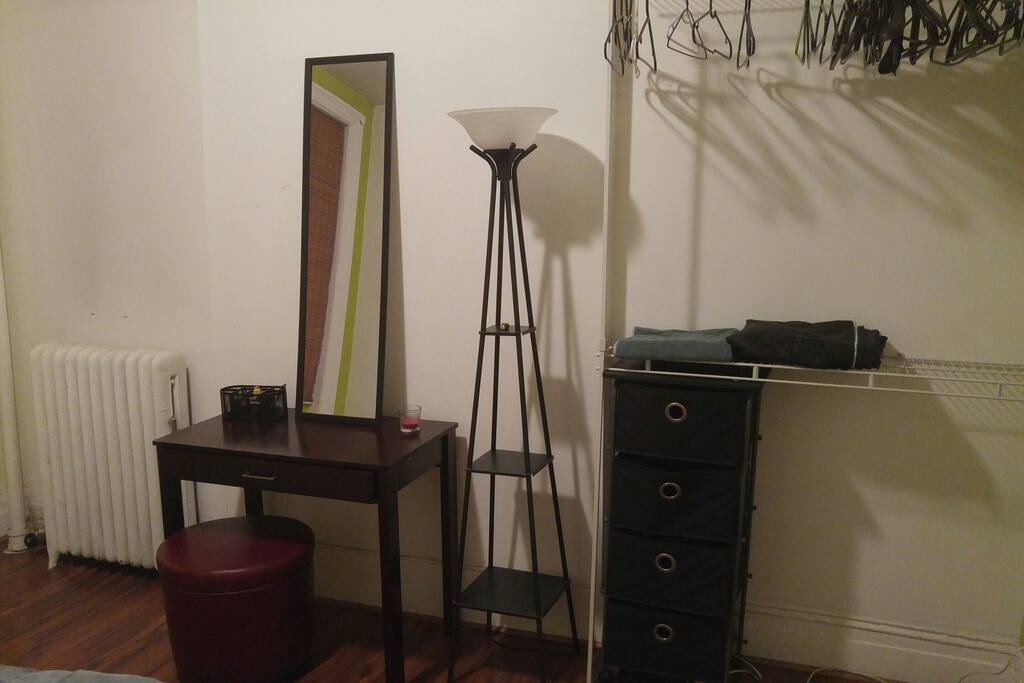 Table w/ ottoman, Area for hanging clothes. There is no built-in closet in this space.