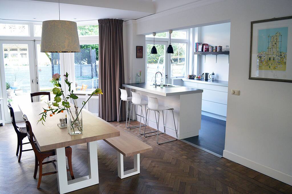 The dinner table and the kitchen in the back