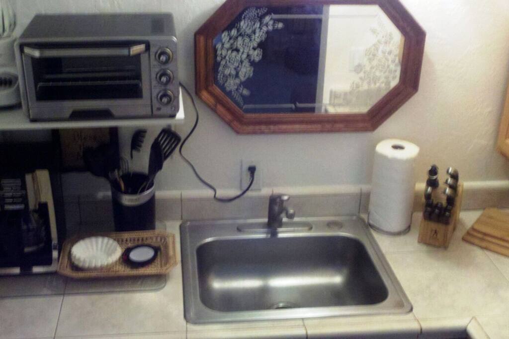 Kitchenette, no oven, sink, toaster oven and coffee pot.