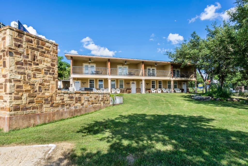 Beautiful yard with 2nd story covered balconies and covered porch