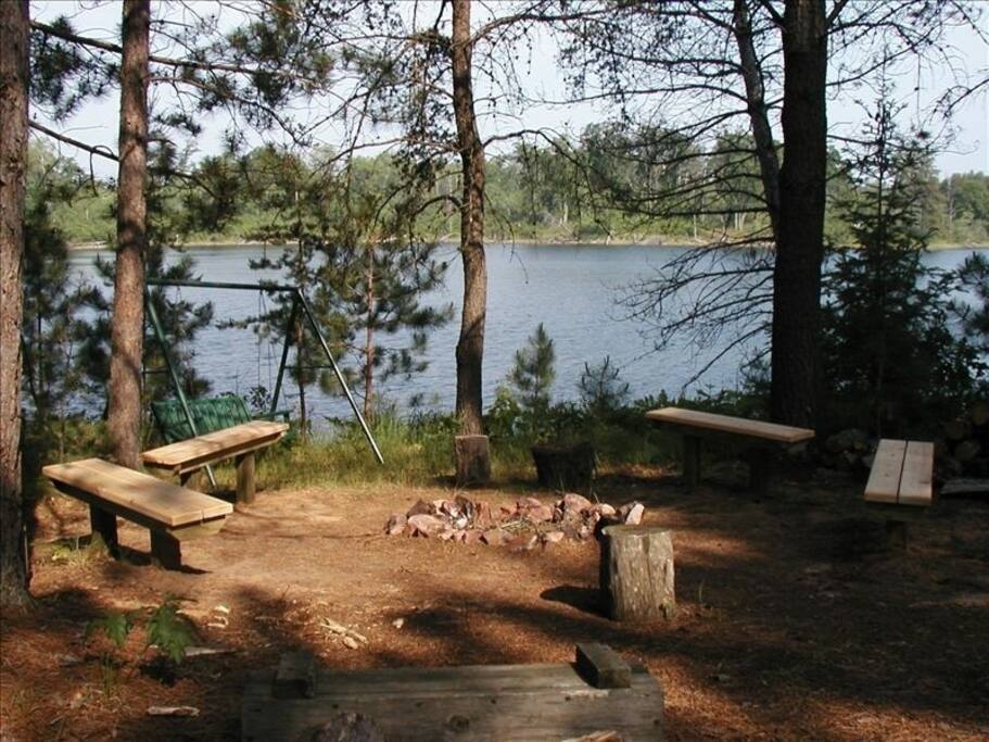 Enjoy a bonfire next to the lake while relaxing on a bench swing.