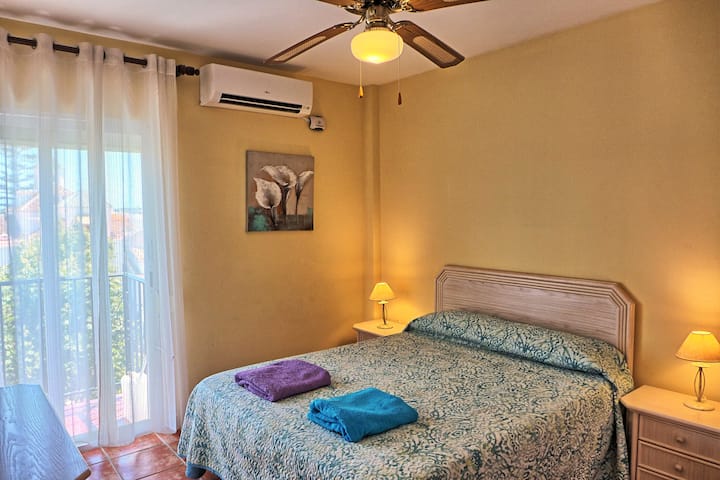 Bedroom three with a 150cm wide double bed, patio doors to the balcony with views over Plaza Cavana and the sea.  All the bedrooms have air conditioning, ceiling fan, window shutters and wardrobe.
