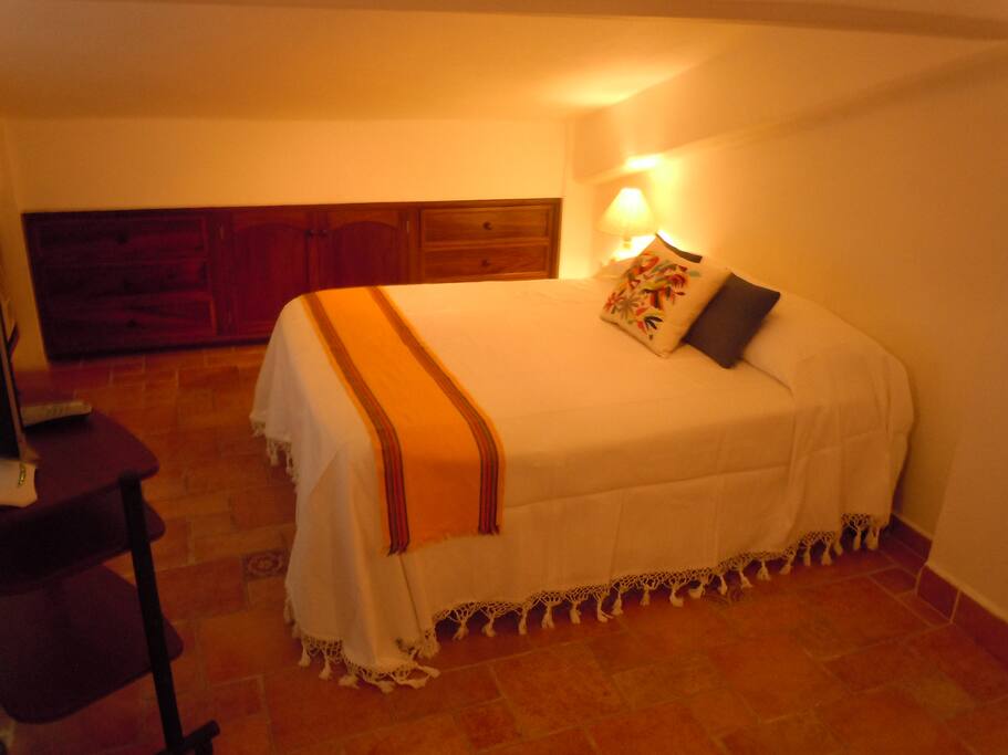 Bedroom with built-in drawers and 19" flat screen TV
