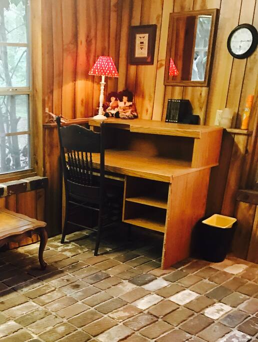 Desk in the den for computer work or writing. The flooring in the den is brick and came from the downtown train depot.(historic)