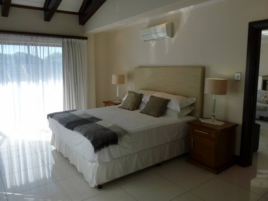 Apartment king extra-length bed with extra large feather/down pillows, air-conditioned