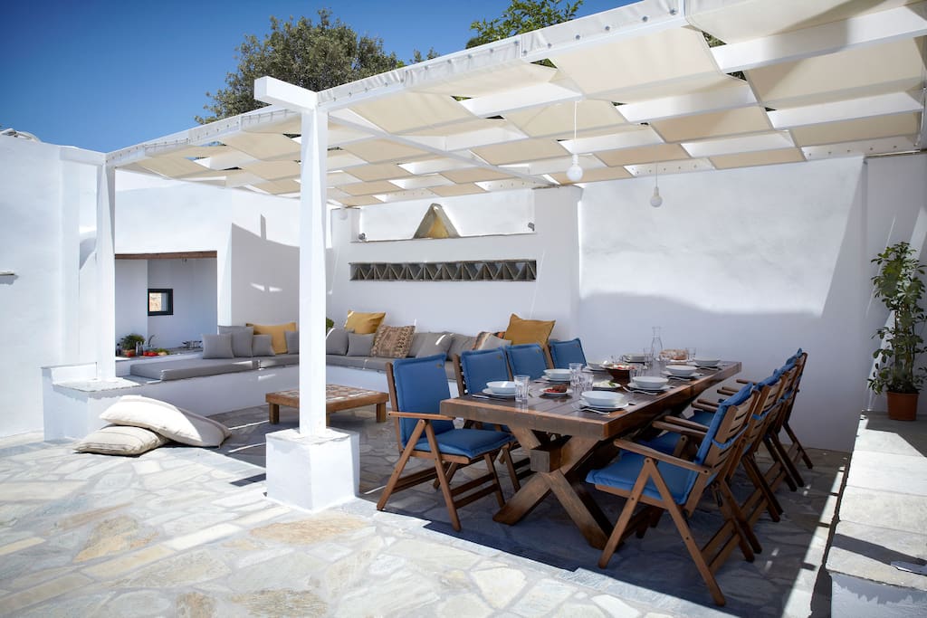 first floor terrace with dining table, lounge and outdoors kitchenette