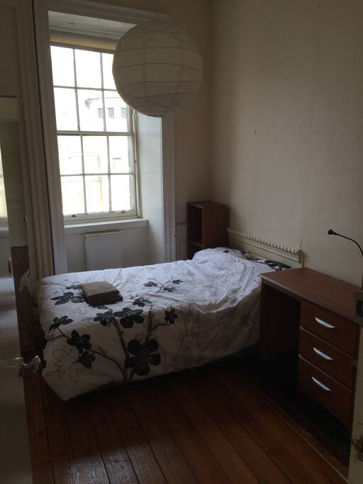 Double bedroom with cupboard, desk and wardrobe