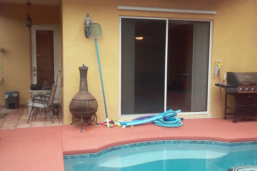 Your room has a sliding glass door out to the pool area. You can use our grill to cook outside.