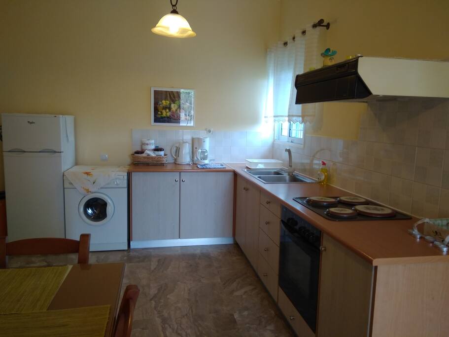 Kitchen with big fridge and washing mashine
