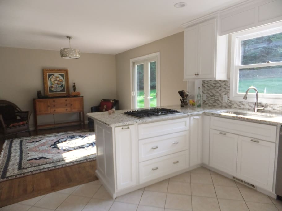 A light, bright kitchen to chat and have a cup of coffee/tea with access to the deck.