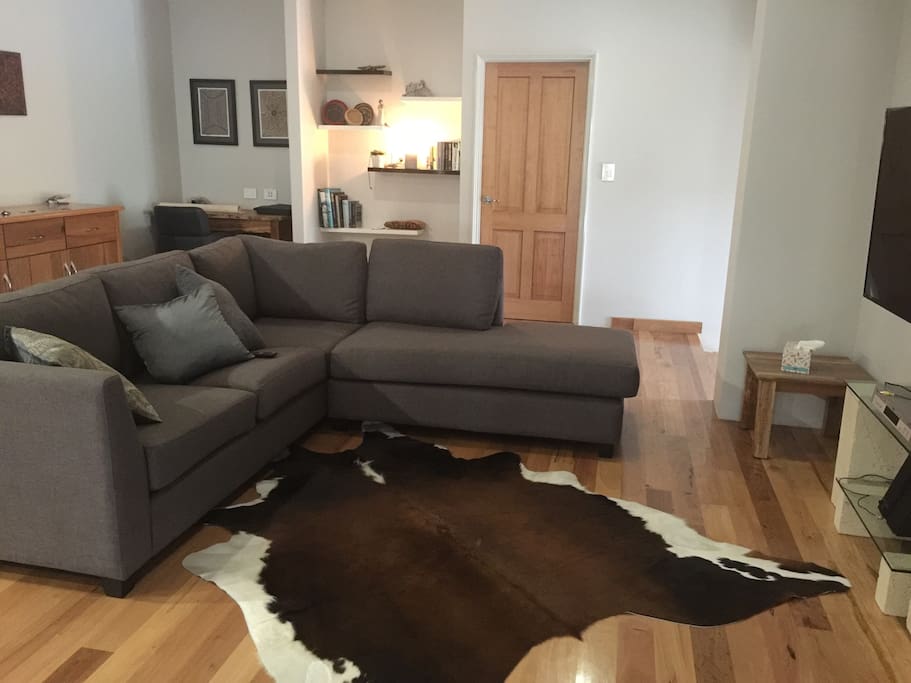 Living area. Large screen TV, Blackbutt floors throughout. Fully air conditioned. Gas heater.