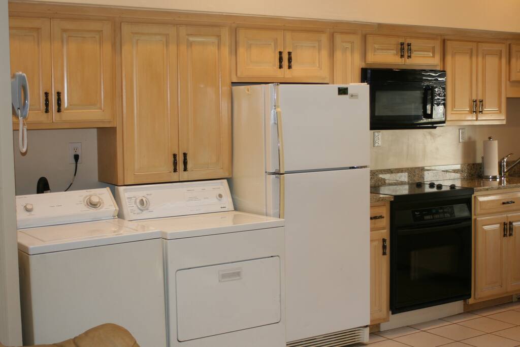 Full size frig with drinks and a washer and dryer with all the necessary laundry stuff.