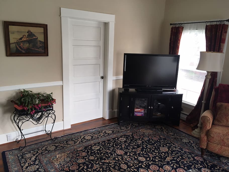 The living room features a 47-inch HDTV with broadcast reception and a wi-fi connected Blu-ray DVD player. The windows have black-out curtains so you can enjoy a movie any time of day.