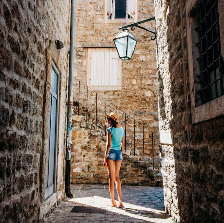 photo of woman in an alley
