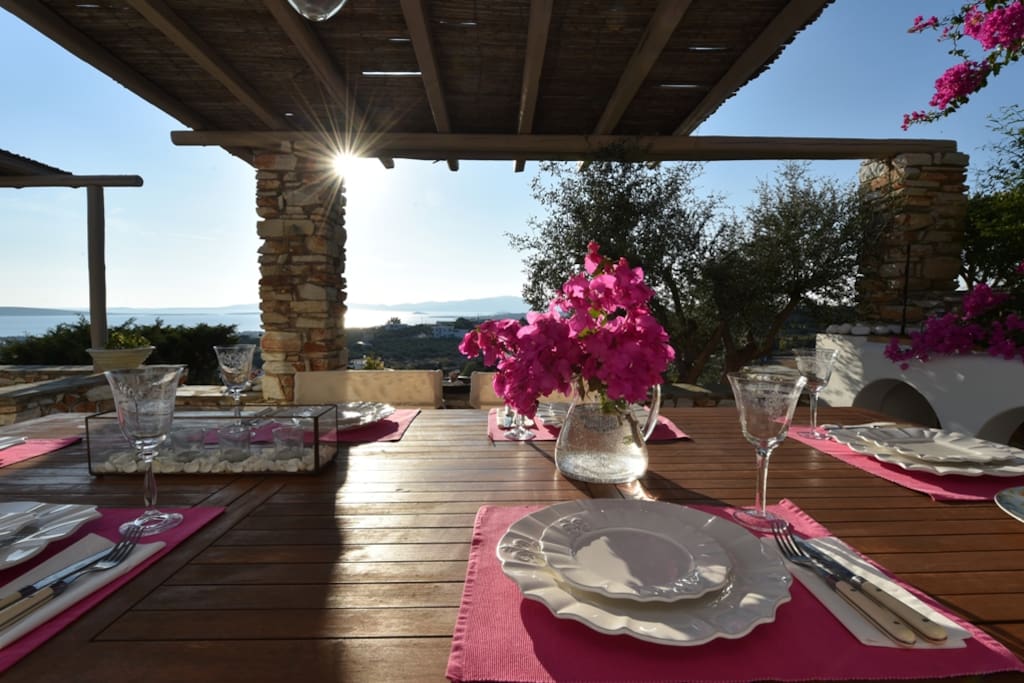 Dining table on the terrace viewing the sea during sunset