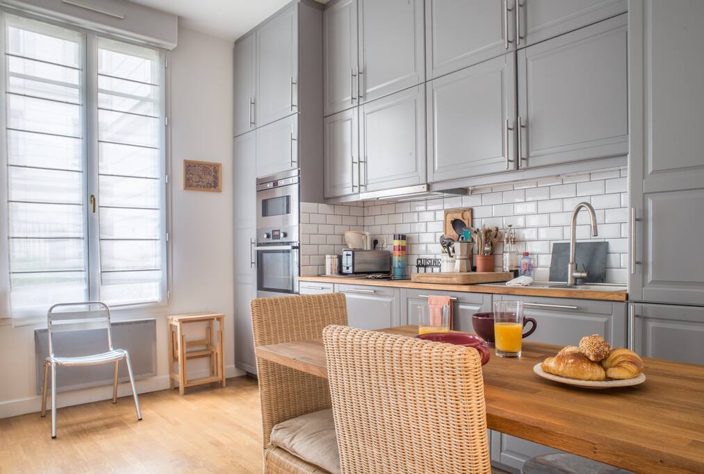 The large living room with dinner table & kitchen fully furnished