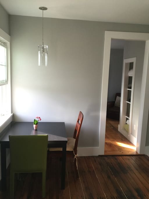 Dining table off of living room - with view onto the unit's exclusive use outdoor deck. (Bedroom entry on the right.)