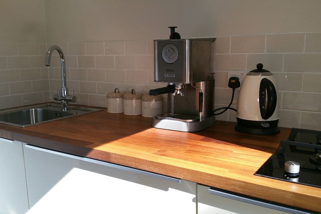 Kitchen with coffee maker, hob, toaster and fridge