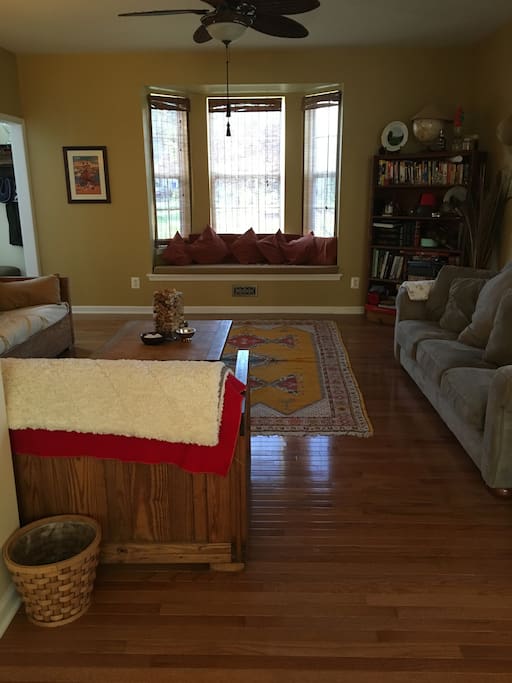 Front room, with window seat with 3 couches, adjacent to the dining room