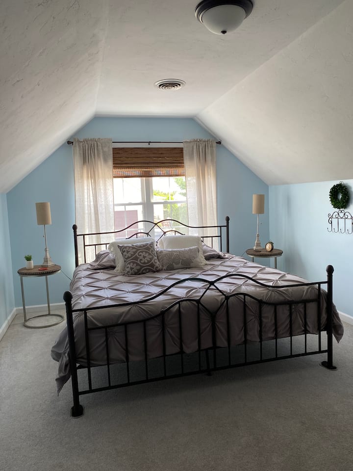 Bedroom 1 - spacious room with king sized bed, dresser, and sitting area with tv