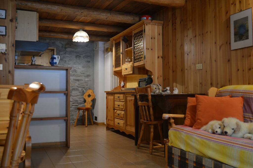 Soggiorno e cucina open space con due finestre.