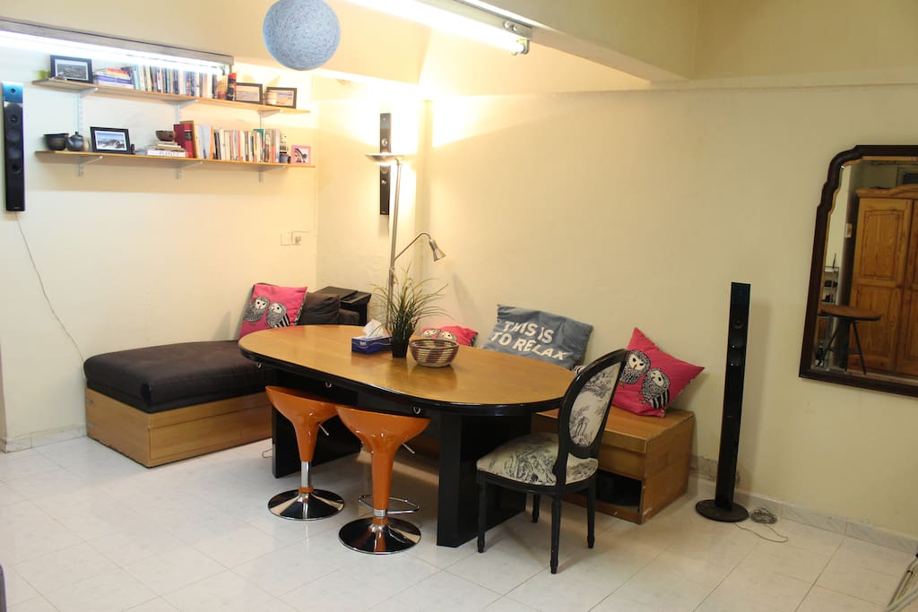 Dining table with adjacent chaise lounge.