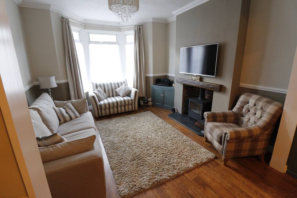 The sitting room with 50" TV, surround sound, fast internet, and fireplace