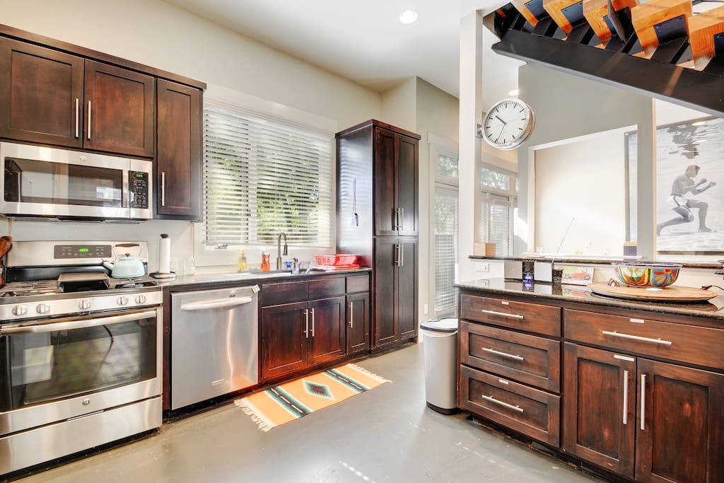 Granite countertops and all stainless steel appliances, including dishwasher, range, and fridge.