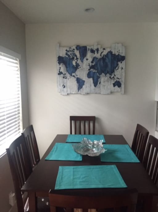 The kitchen table is spacious and ready for you to enjoy your morning coffee on.
