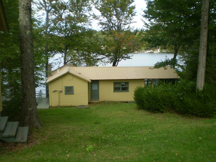 Crane Cottage with screened-in porch on the right and Sand Pond in the background