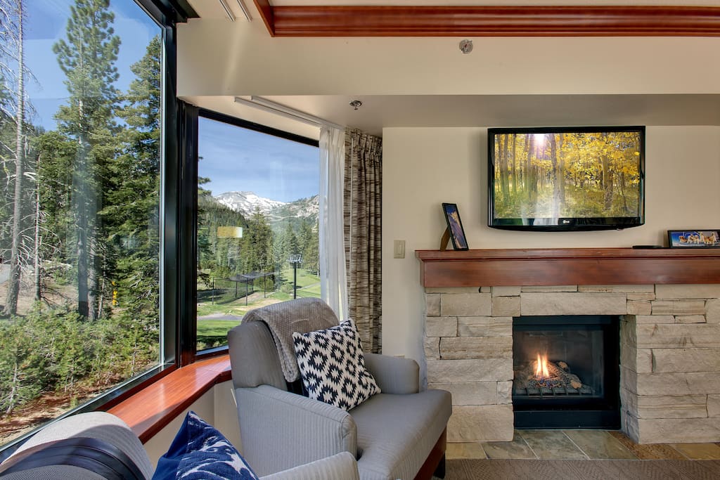 Living room w/ a view. Cozy up to the fireplace.