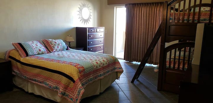 Queen size bed with a pair of bunk beds. Has it's own private bathroom. Located downstairs. Ocean view!