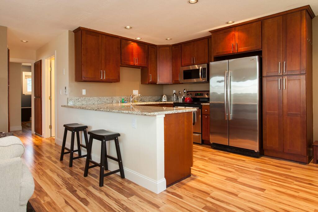 Spacious kitchen with bar seating along the hallway.