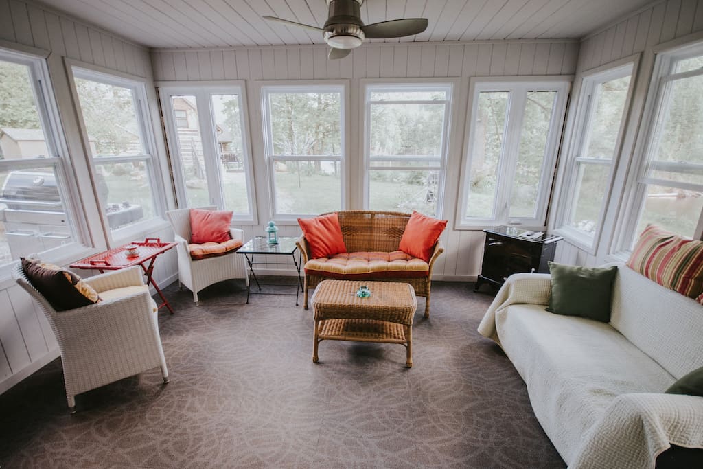 Sunroom with electric fireplace.