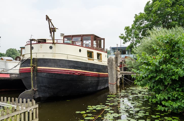 Authentic barge in the river Amstel in Amsterdam
