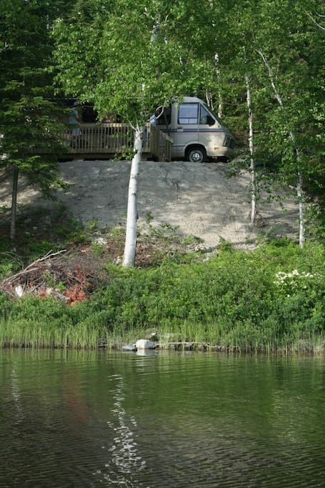 Right on the water (there are now stairs and a dock)