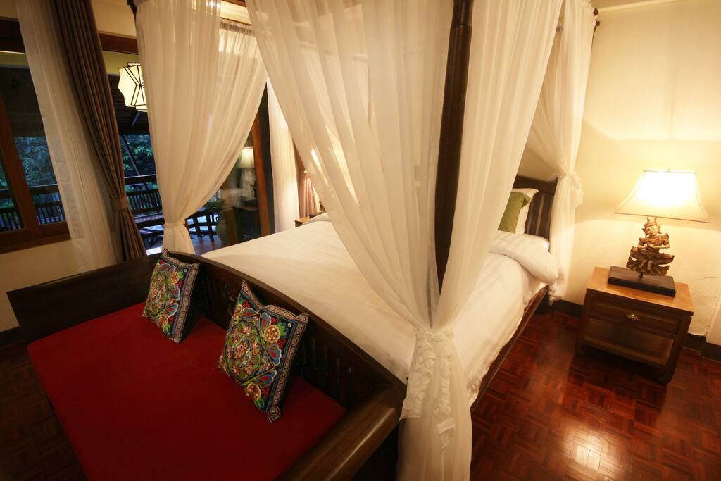 Deluxe bedroom upstairs with one king-size canopy bed and comfy mattress as well as luxurious bed sheets and large balcony.