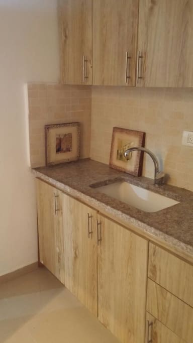 Equipped with kitchen cabinets and drawers, kettle, utensils and microwave oven