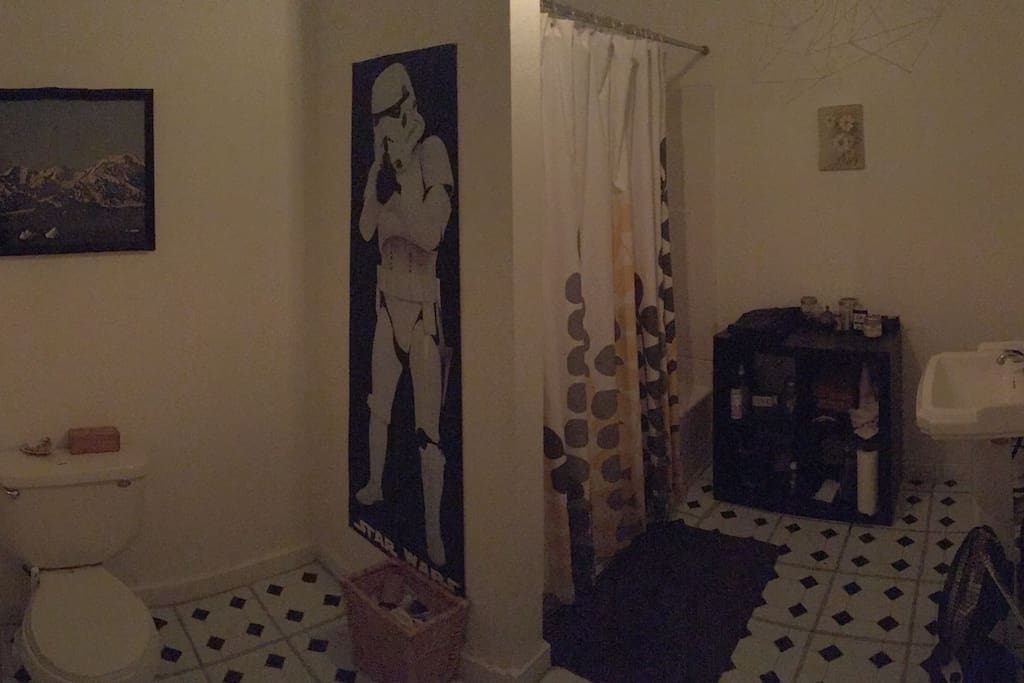 Shared bathroom next to bedroom door.