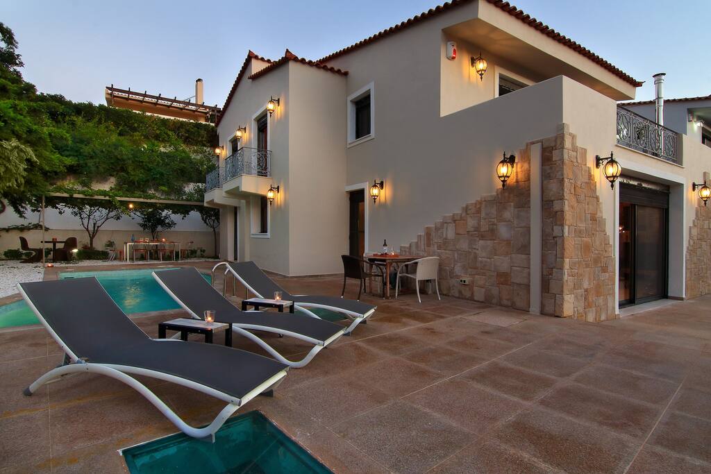 Exterior of the villa with lounge area next to the pool