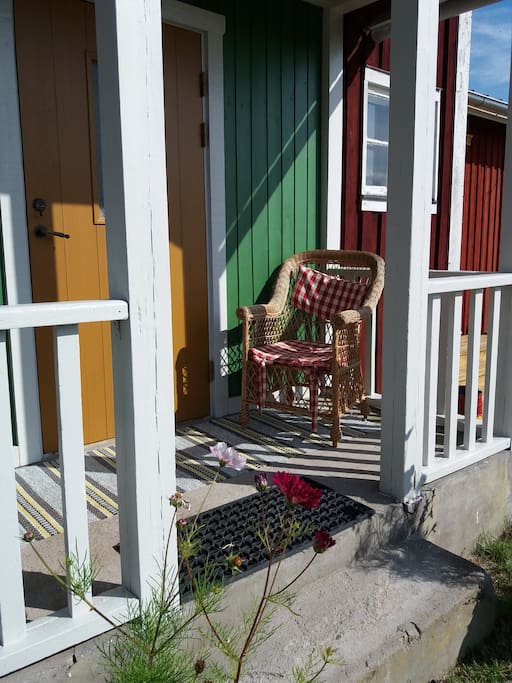 Ockragul dörr, kromoxidgrön verandavägg.