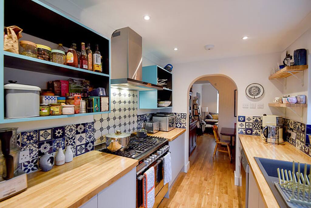 Bespoke kitchen with handmade Mexican tiles and a huge double oven with lots of work space for cooking.