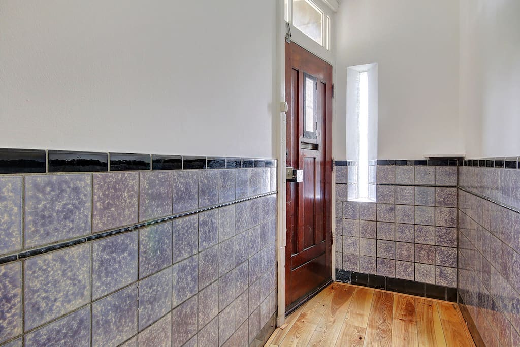 Entrance hall with pretty original wall tiles.