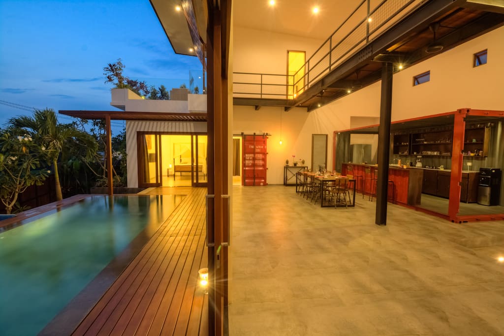 Full length glass doors sliding open to the pool deck