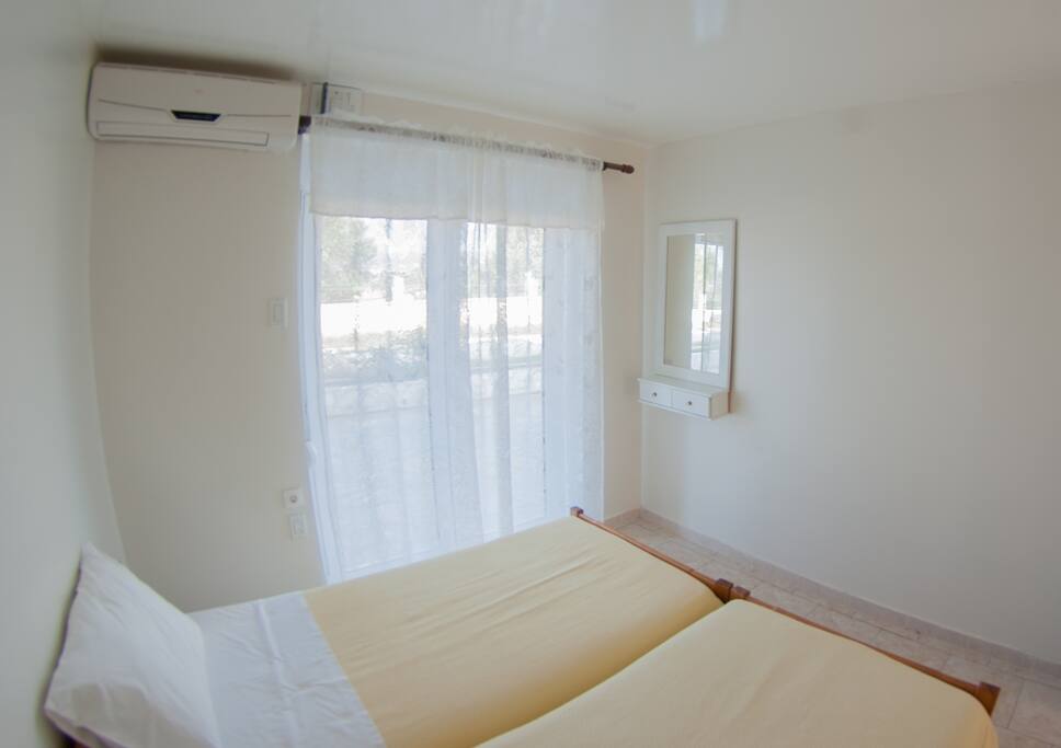 Two single beds. Door leads to garden terrace facing sea.