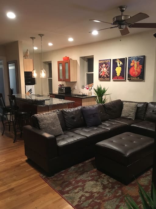 Living Room, comfortable leather couch w/ blankets in ottoman