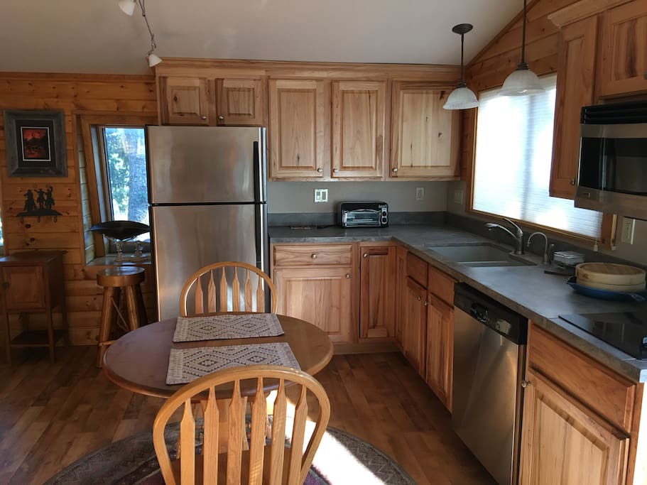 The kitchen has a microwave, coffee pot, dish washer, toaster oven and two burners.
