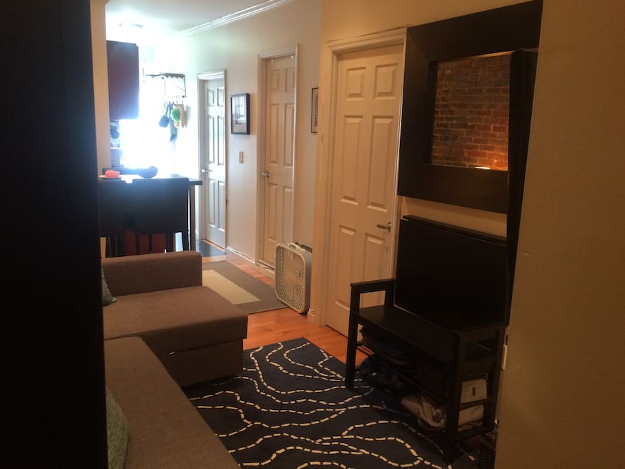 Main living space with doors to the bathroom and 2 bedrooms visible.